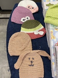 a group of knitted hats on a table