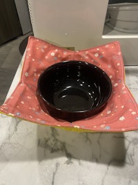 a bowl sitting on top of a microwave