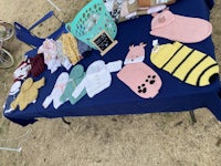 a table with a variety of knitted items on it